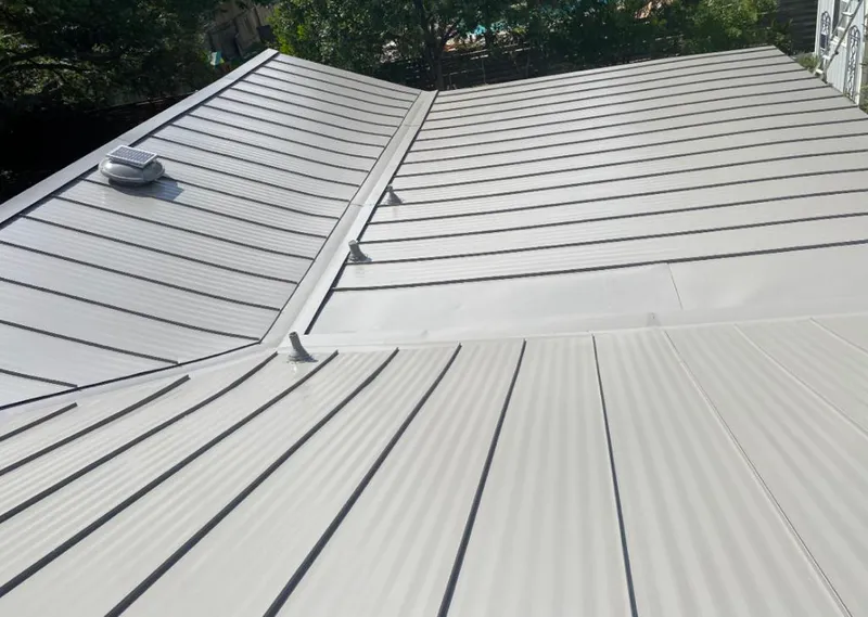 Solar attic fan installed on a metal roof for Roof Ventilation in Traverse City